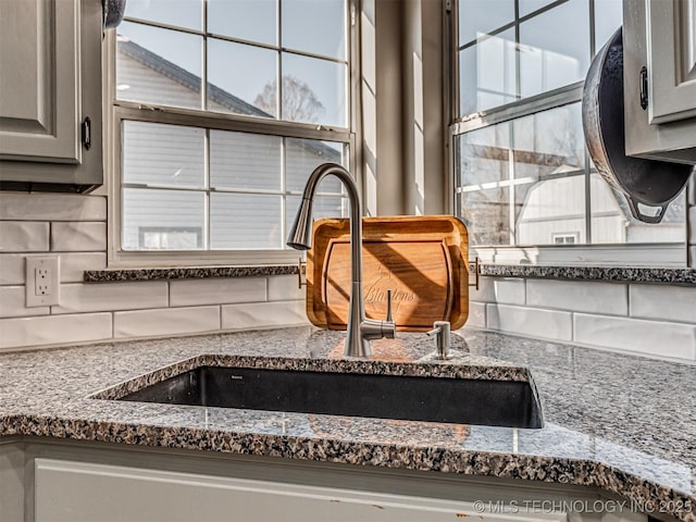 room details featuring decorative backsplash and sink