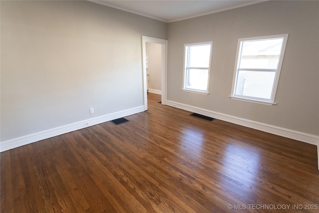 unfurnished room featuring crown molding and dark hardwood / wood-style flooring