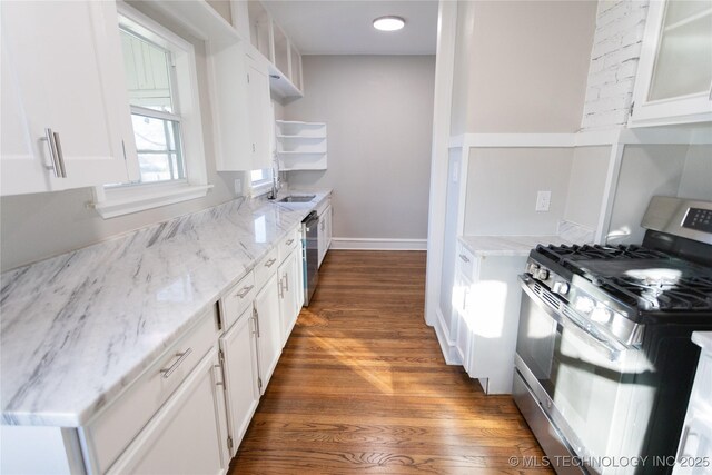 kitchen featuring white cabinets, sink, light stone counters, and stainless steel appliances