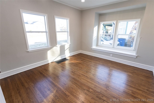 unfurnished room featuring hardwood / wood-style floors and ornamental molding