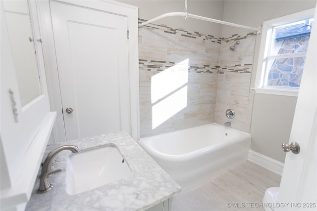 bathroom featuring vanity and tiled shower / bath combo