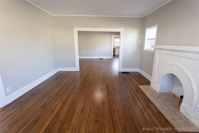 unfurnished living room with dark hardwood / wood-style flooring, a brick fireplace, and ornamental molding