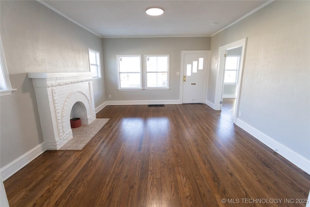 unfurnished living room featuring crown molding, a fireplace, and dark wood-type flooring