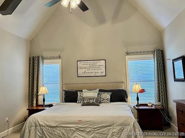 carpeted bedroom with multiple windows, ceiling fan, and lofted ceiling