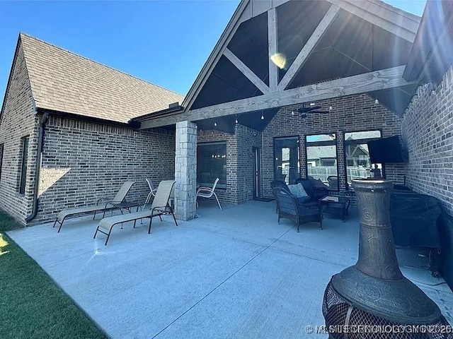 view of patio with an outdoor living space and ceiling fan