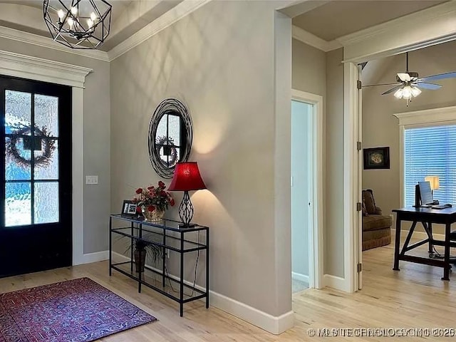 entryway featuring light hardwood / wood-style flooring, a chandelier, and ornamental molding