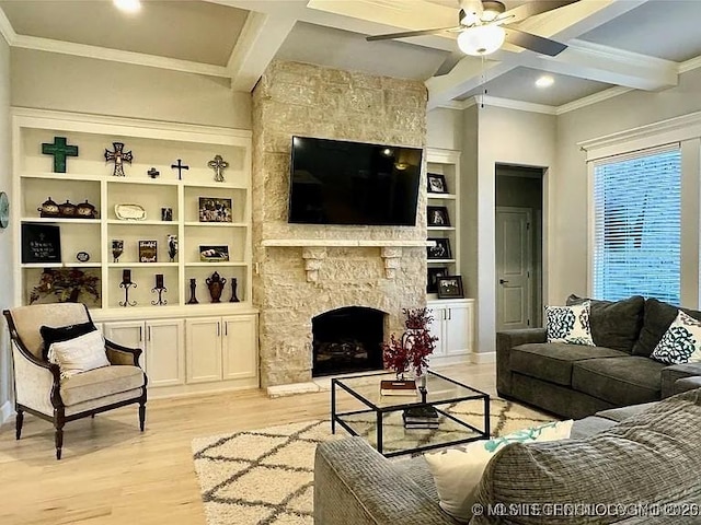 living room with light hardwood / wood-style flooring, ceiling fan, built in features, a fireplace, and beam ceiling