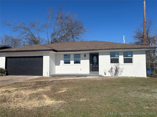 view of front of house featuring a garage and a front lawn