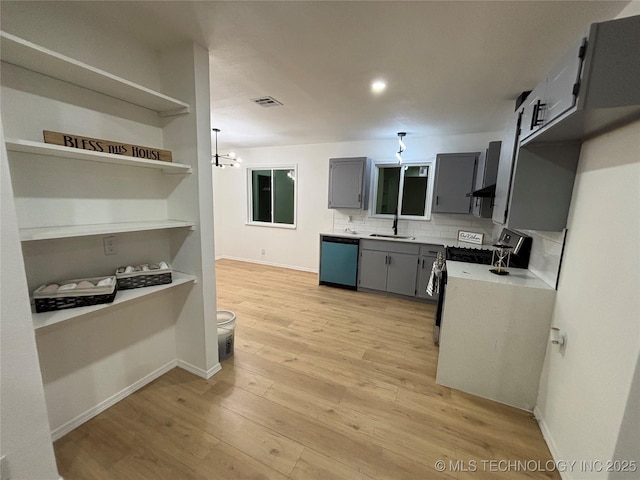 kitchen with dishwasher, stove, sink, light wood-type flooring, and gray cabinetry