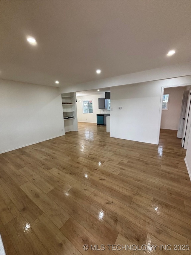 unfurnished living room featuring hardwood / wood-style flooring