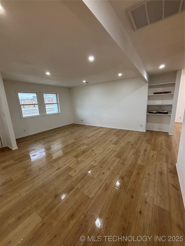 unfurnished living room featuring light wood-type flooring