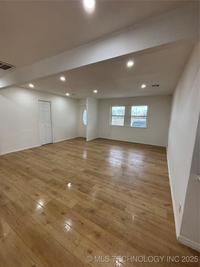 basement with light hardwood / wood-style flooring