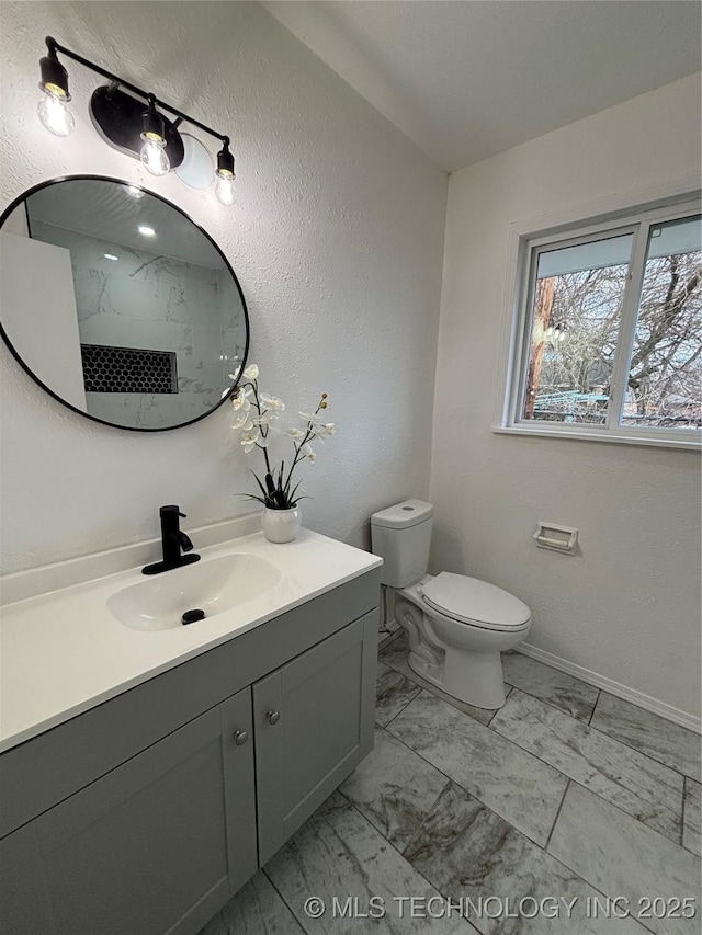 bathroom featuring toilet and vanity