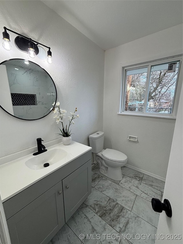 bathroom featuring toilet and vanity