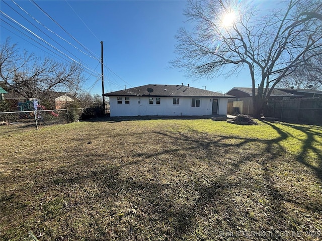 rear view of property with a yard