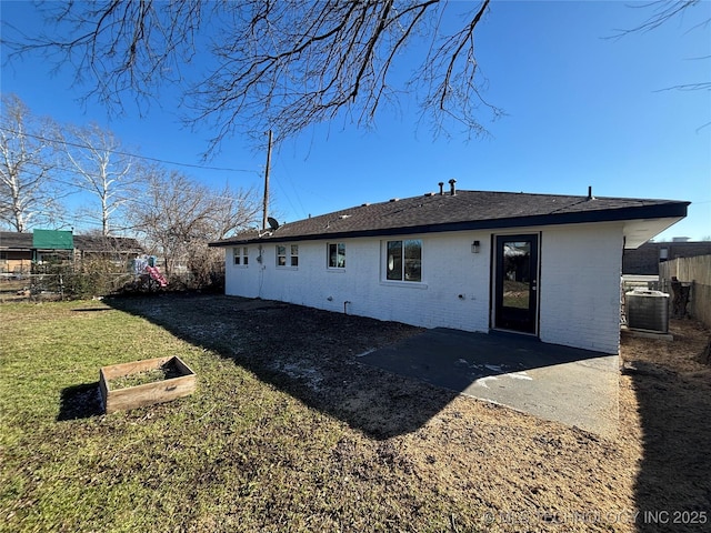 back of property with cooling unit and a yard