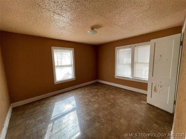 empty room with a textured ceiling