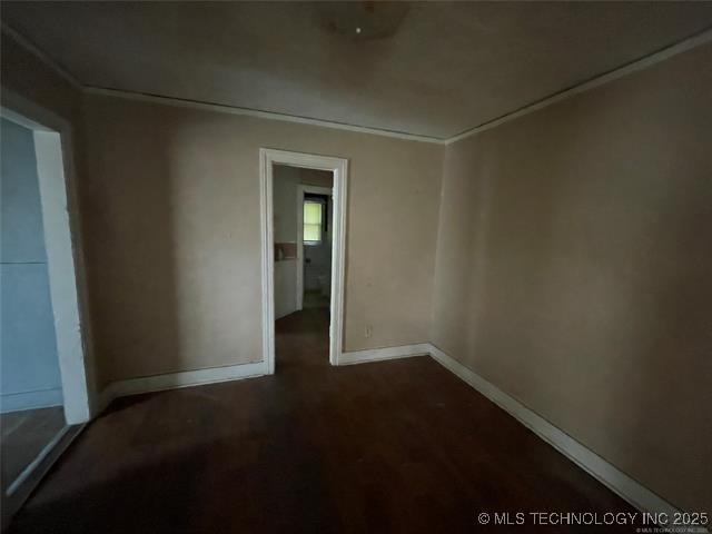 unfurnished room with dark wood-type flooring