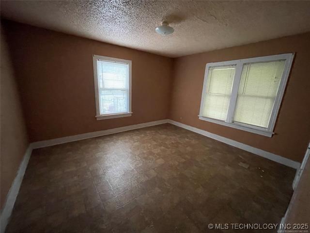 empty room with a textured ceiling