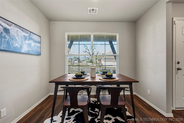 dining space with dark hardwood / wood-style flooring