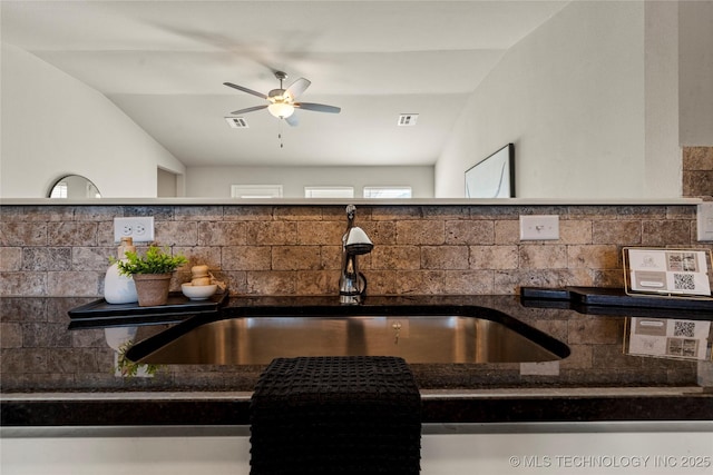 kitchen with tasteful backsplash, ceiling fan, lofted ceiling, and sink