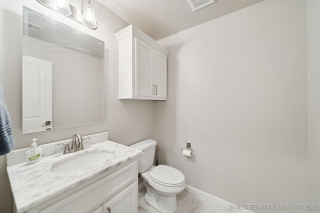 bathroom with toilet and vanity