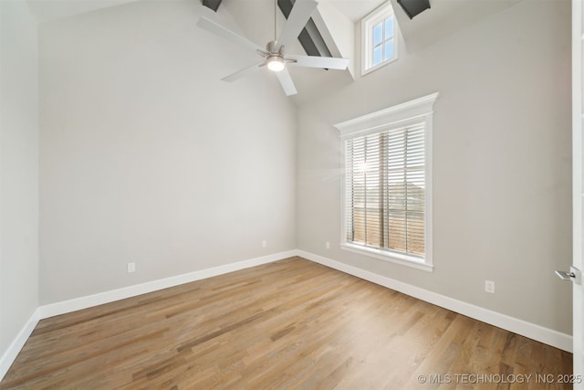 spare room with high vaulted ceiling, hardwood / wood-style floors, ceiling fan, and beamed ceiling