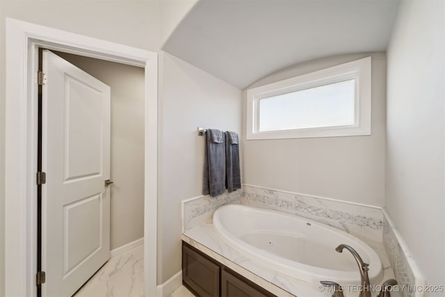 bathroom featuring a bathing tub and vaulted ceiling