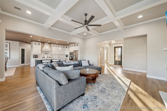 living room with beam ceiling, ceiling fan, light hardwood / wood-style flooring, and coffered ceiling