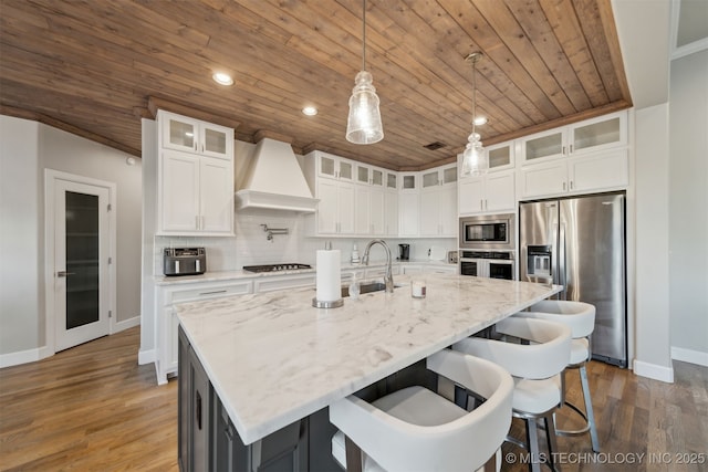 kitchen featuring a center island with sink, wooden ceiling, and appliances with stainless steel finishes