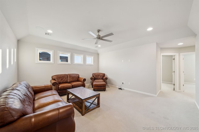 carpeted living room with ceiling fan and vaulted ceiling