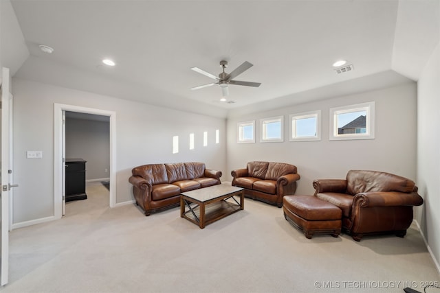 living room with ceiling fan, light colored carpet, and vaulted ceiling