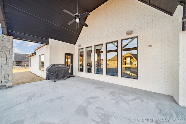 view of patio with ceiling fan and a grill