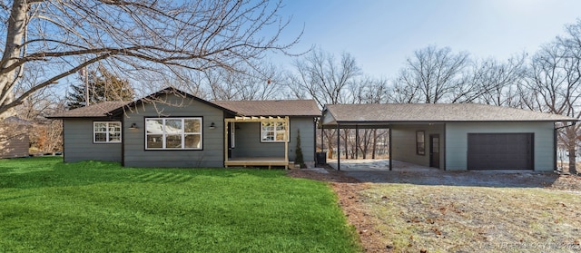 single story home with a front yard, a garage, and a carport