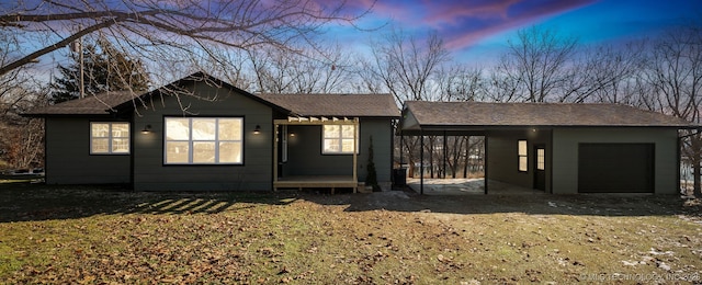 single story home featuring a garage and a carport