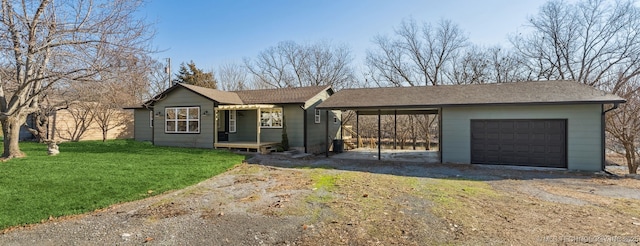 ranch-style house featuring a garage, a front lawn, and a carport