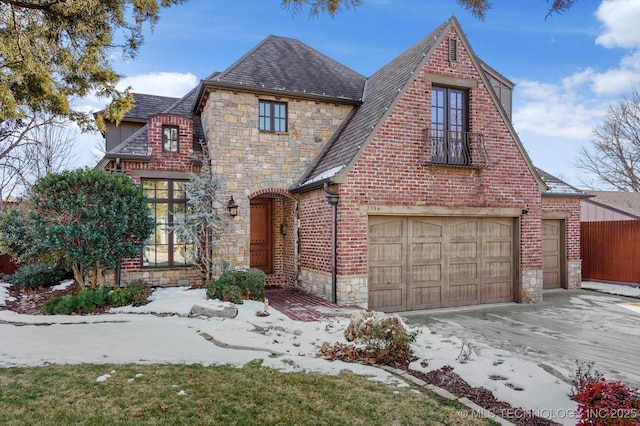 tudor-style house featuring a garage