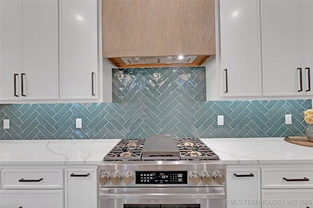 kitchen featuring light stone counters, custom range hood, gas stove, and tasteful backsplash