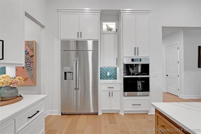 kitchen with white cabinetry and appliances with stainless steel finishes