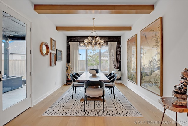 dining area with beam ceiling, a chandelier, and light wood-type flooring