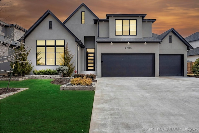 view of front of home with a garage and a lawn