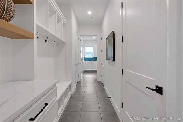 mudroom featuring dark tile patterned flooring