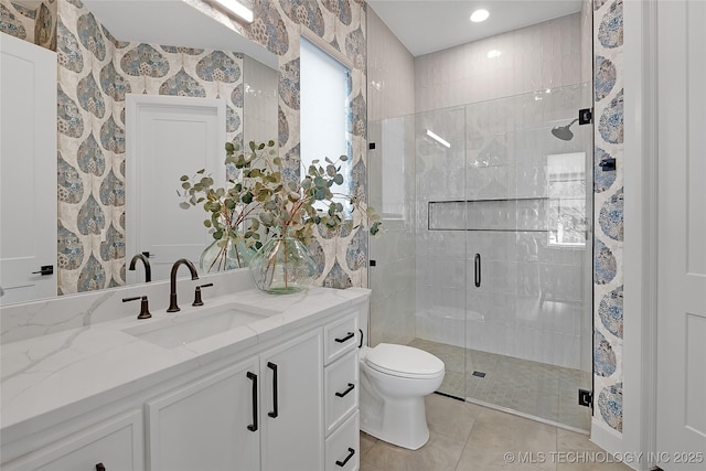 bathroom featuring a shower with door, tile patterned floors, toilet, and vanity