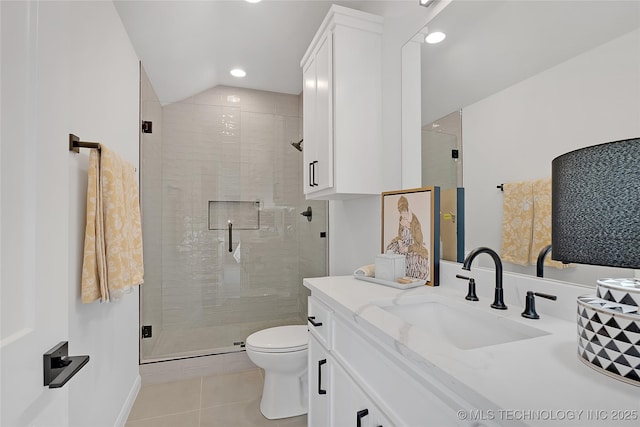 bathroom featuring toilet, tile patterned floors, vanity, a shower with door, and lofted ceiling