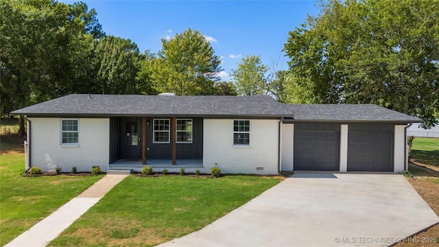 single story home featuring covered porch, a garage, and a front yard