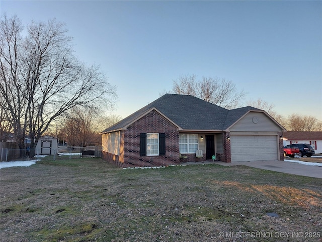 ranch-style home featuring a yard, a garage, and a storage shed