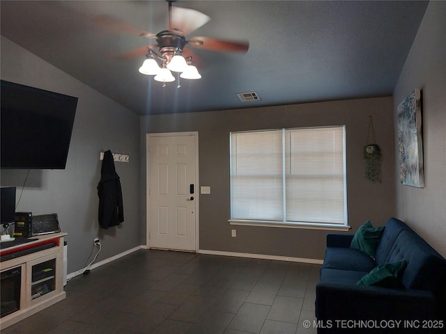 living room featuring ceiling fan and lofted ceiling