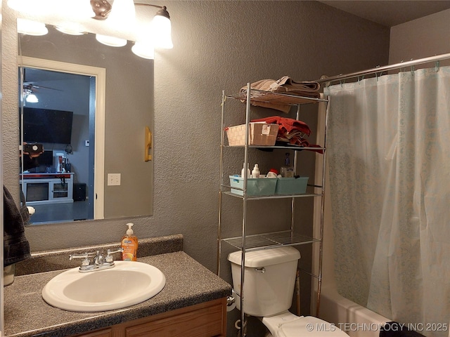 full bathroom with vanity, ceiling fan, toilet, and shower / bath combo