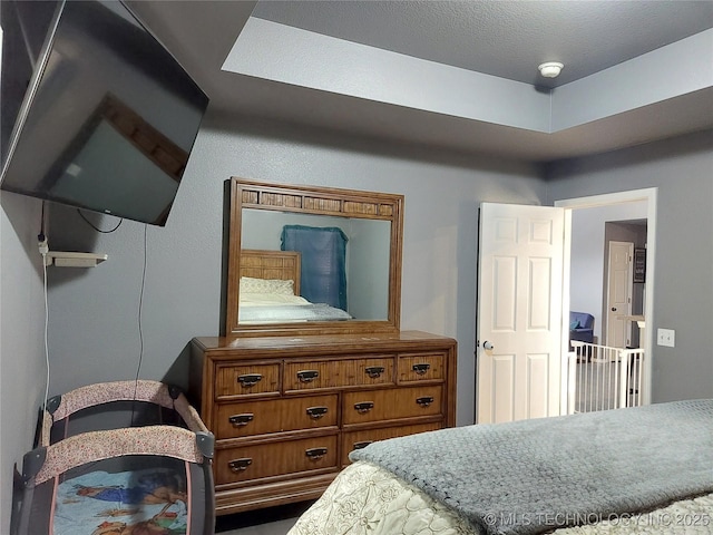 bedroom with a raised ceiling