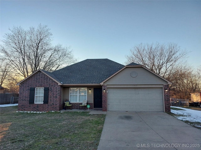 single story home with a garage and a yard